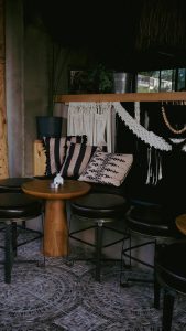 Warm and inviting indoor seating area with rustic furniture and bohemian decor elements.